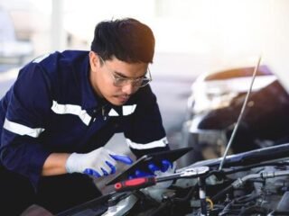 auto-mechanic-is-working-on-car-engine-in-mechanic-shop-a-mechanic-in-uniform-is-working-on-a-car-service-work-in-repair-shops-and-maintenance-services-photo