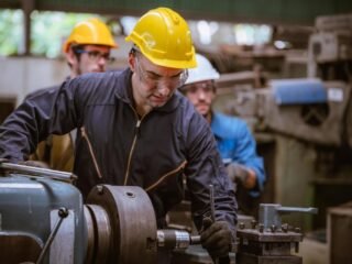 industry-engineering-wearing-safety-uniform-control-operating-computer-controlled-lathe-grinding-machine-working-in-industry-factory-free-photo