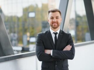 portrait-of-a-smiling-businessman-in-a-modern-business-environment-photo