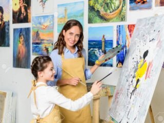 109464005-smiling-teacher-and-pupil-painting-in-workshop-of-art-school