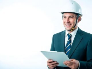 professional-engineer-smiling-wearing-hard-hat-and-suit-holding-clipboard-ready-for-construction-site-management-photo