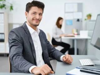 depositphotos_87969200-stock-photo-manager-sitting-at-desk-and