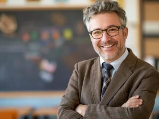 middleaged-male-school-teacher-smiling-in-classroom-education-and-learning-concept-for-posters-and-print-design-photo