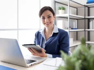 depositphotos_100611092-stock-photo-smiling-office-worker-using-a